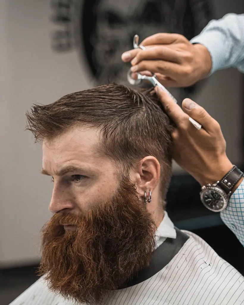 Barba larga peinada y tijera en la mano