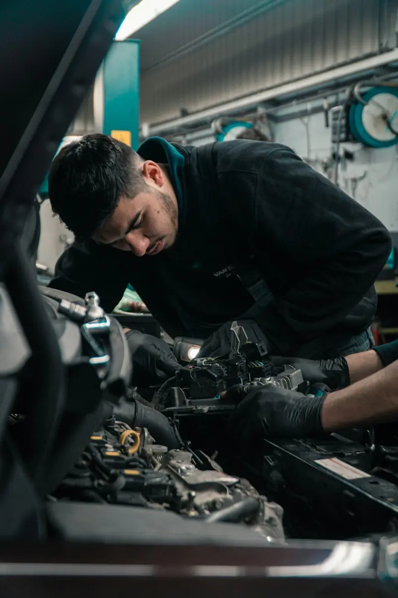 Un mecánico trabajando en el motor de un coche